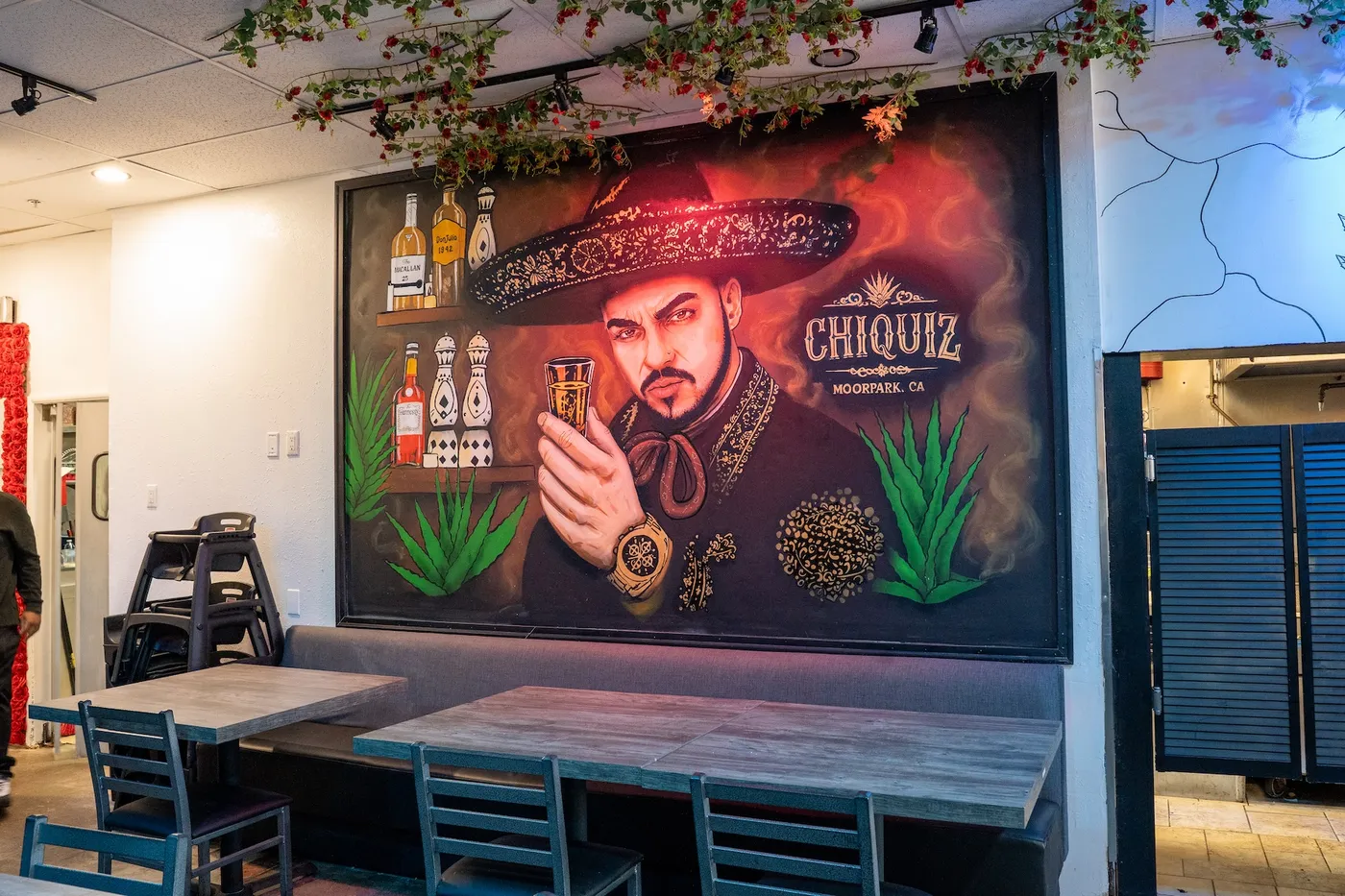 Charro mural above the booth seating at Casa Chiquiz